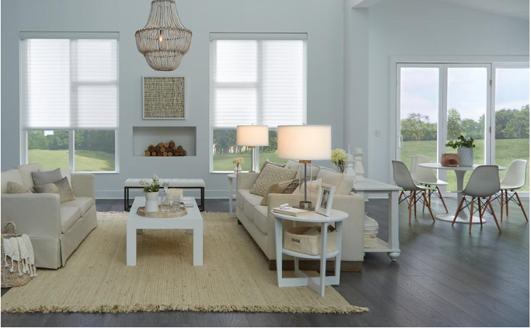 A living room featuring Lutron lights and smart shades.  