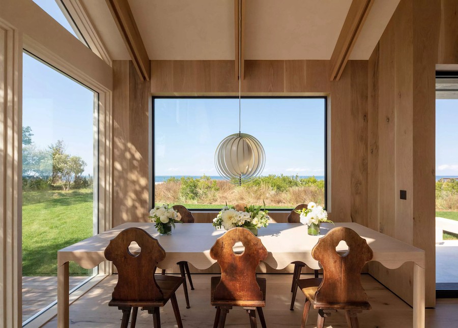 A dining area with Lutron lighting fixtures in a Cape Cod home overlooking the ocean.