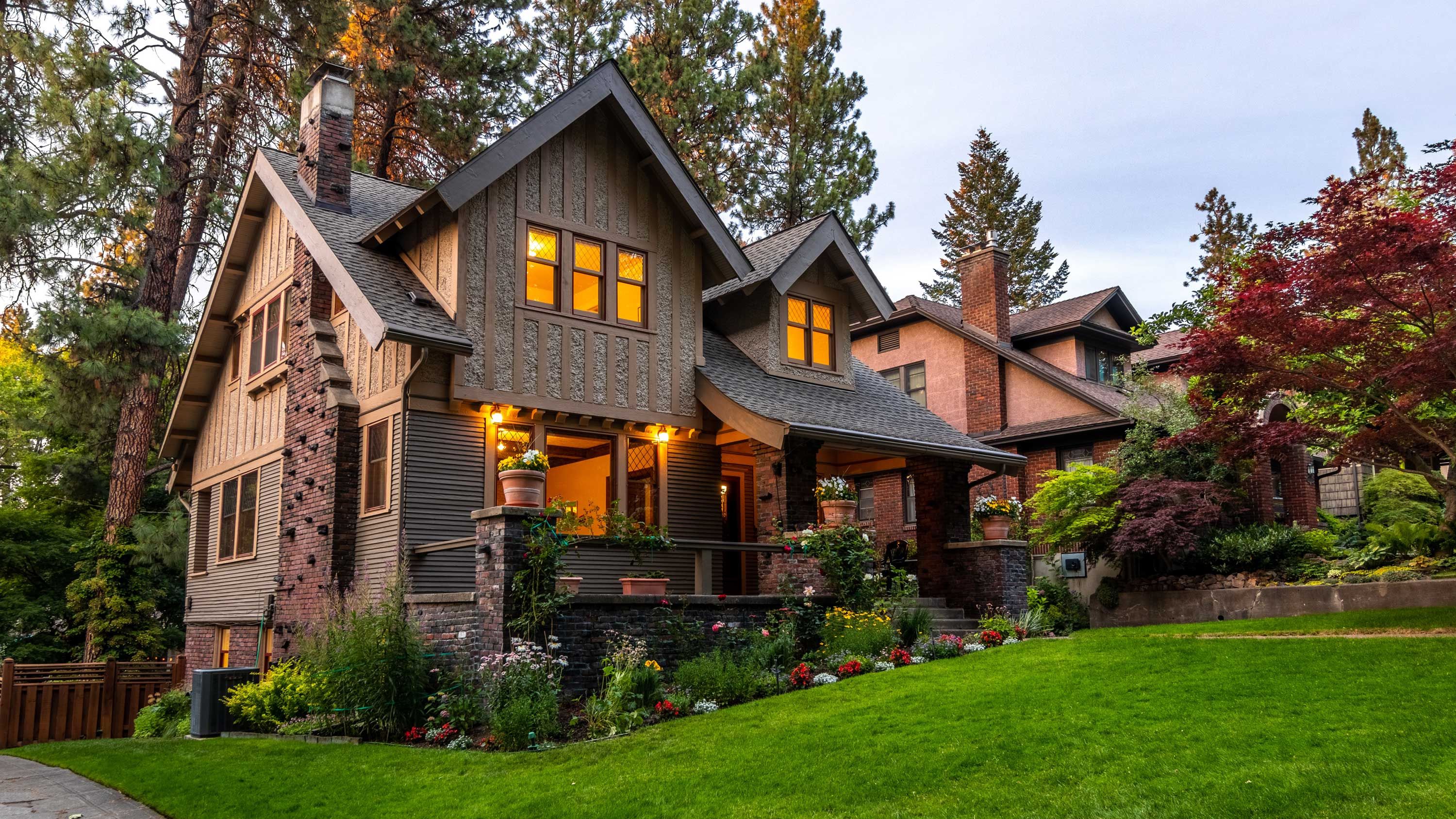 home on hill with brown siding at dusk